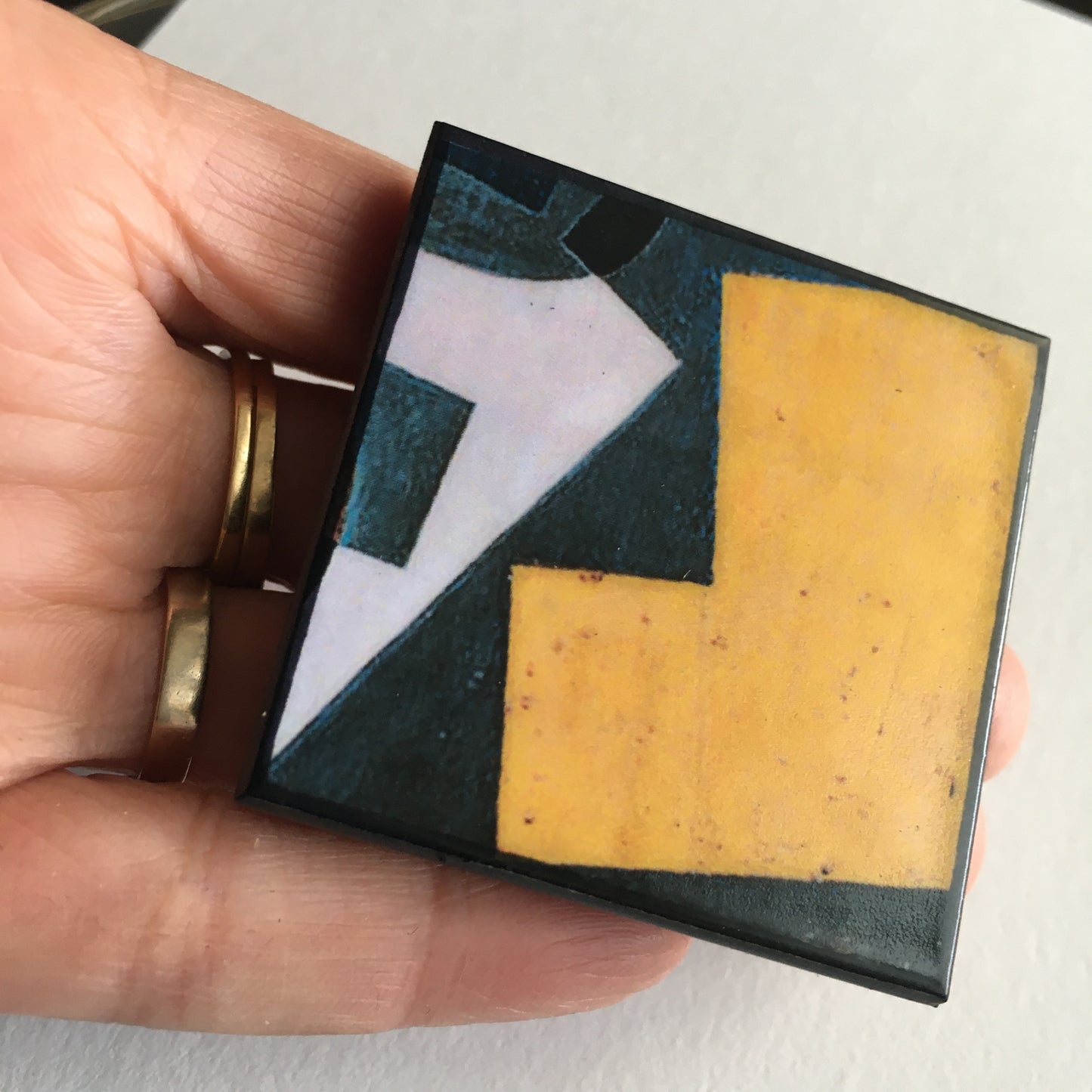 Art detail from Cubism painting by Spanish artist Juan Gris. Sustainable square brooch handmade from wood by Obljewellery