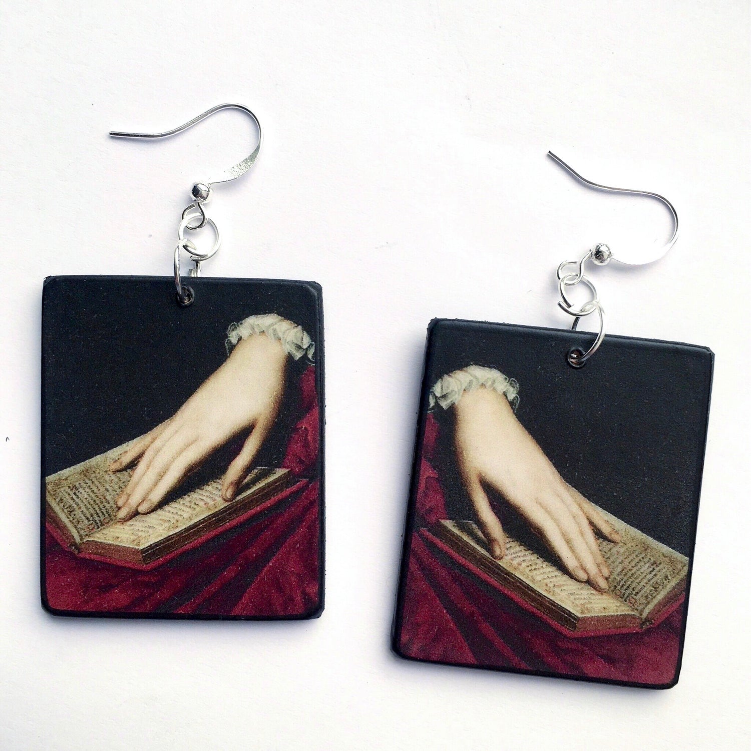 Mismatched wooden earrings inspired by a Bronzino's  Renaissance painting.  Art detail of a hand on top of a book. Welcome to Obljewellery statement art earrings collection. 