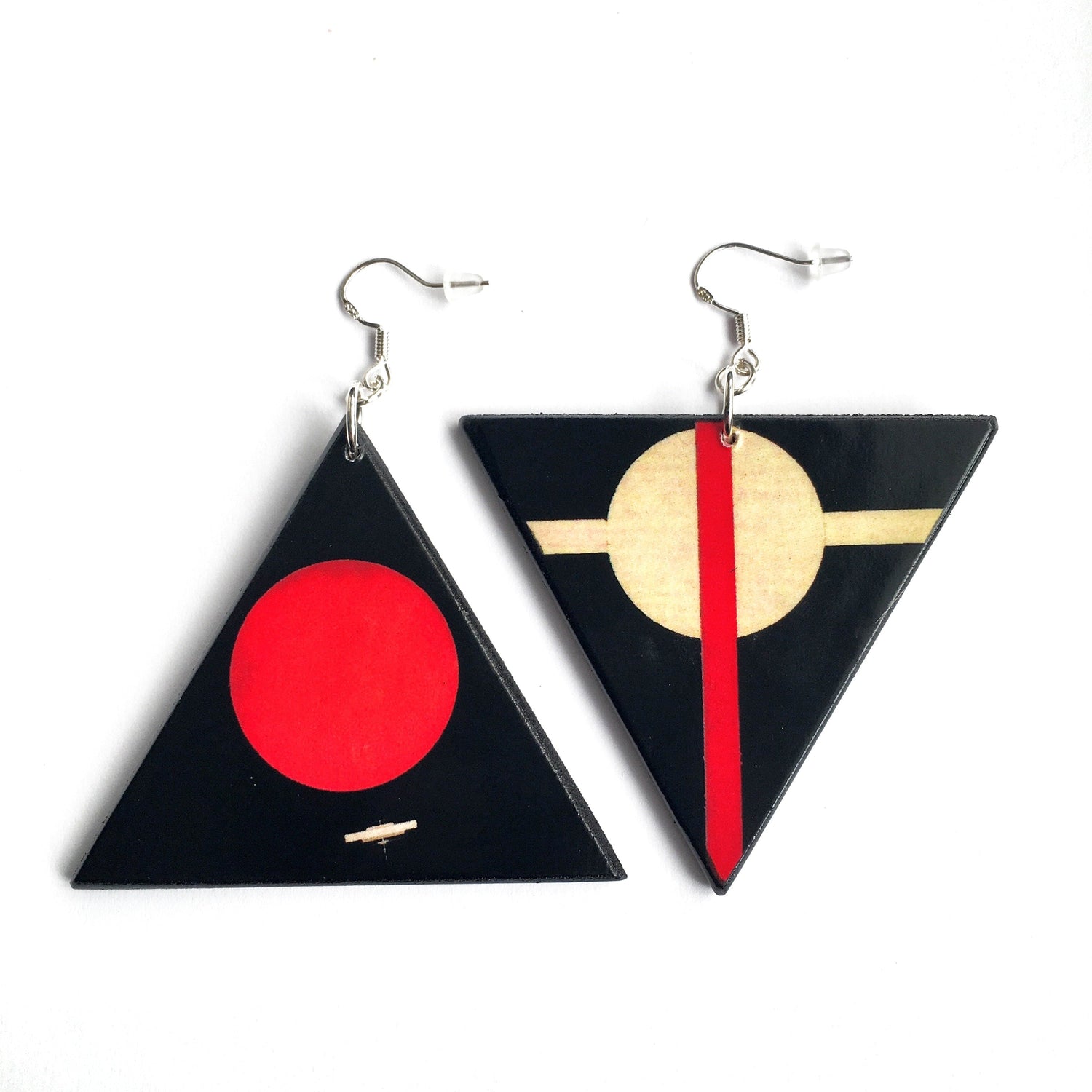Asymmetrical, mismatched, triangular, wooden earrings. Quirky triangular shaped earrings with a geometric art detail inspired by the artist Il'ia Chashnik. Dangle earrings in black and red circle.