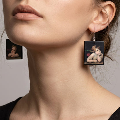 #A pair of asymmetric art earrings inspired by the iconic cherubim detail from The Sistine Madonna by Raphael (Raffaello Sanzio) — one of the most recognisable images in the history of Western art