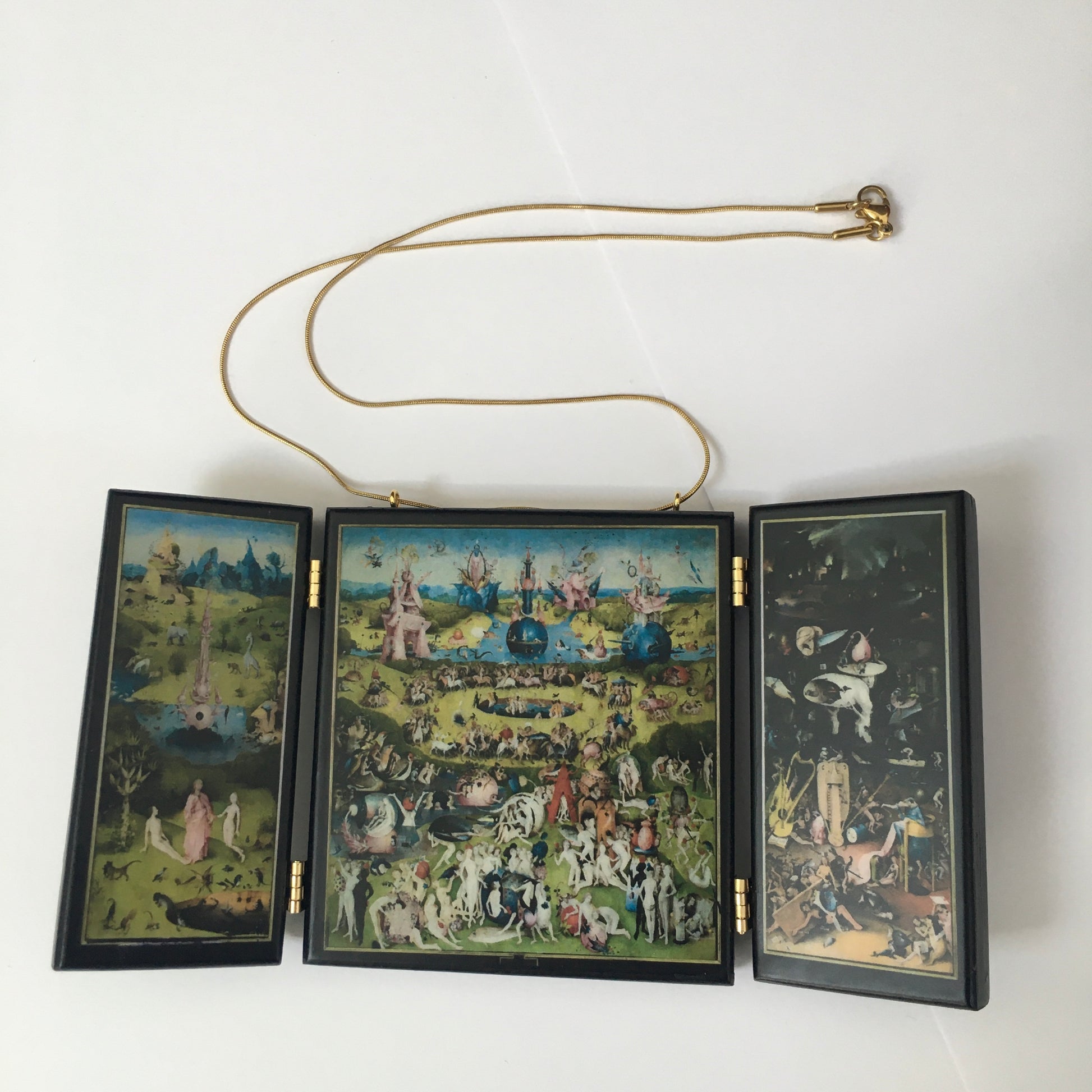 A fully functioning, reproduction in miniature of the three panelled masterpiece, Garden of Earthly Delights by Hieronymus Bosch, turned into a beguiling necklace. 