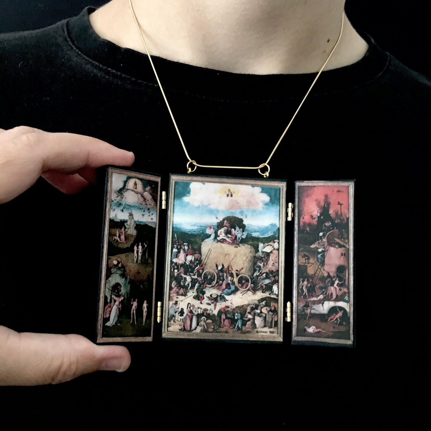 Triptych miniature art necklace handmade from sustainable wood reproduce The Haywain painting by Hieronymus Bosch. This aesthetic fully functioning art pendant necklace is created and designed by Obljewellery