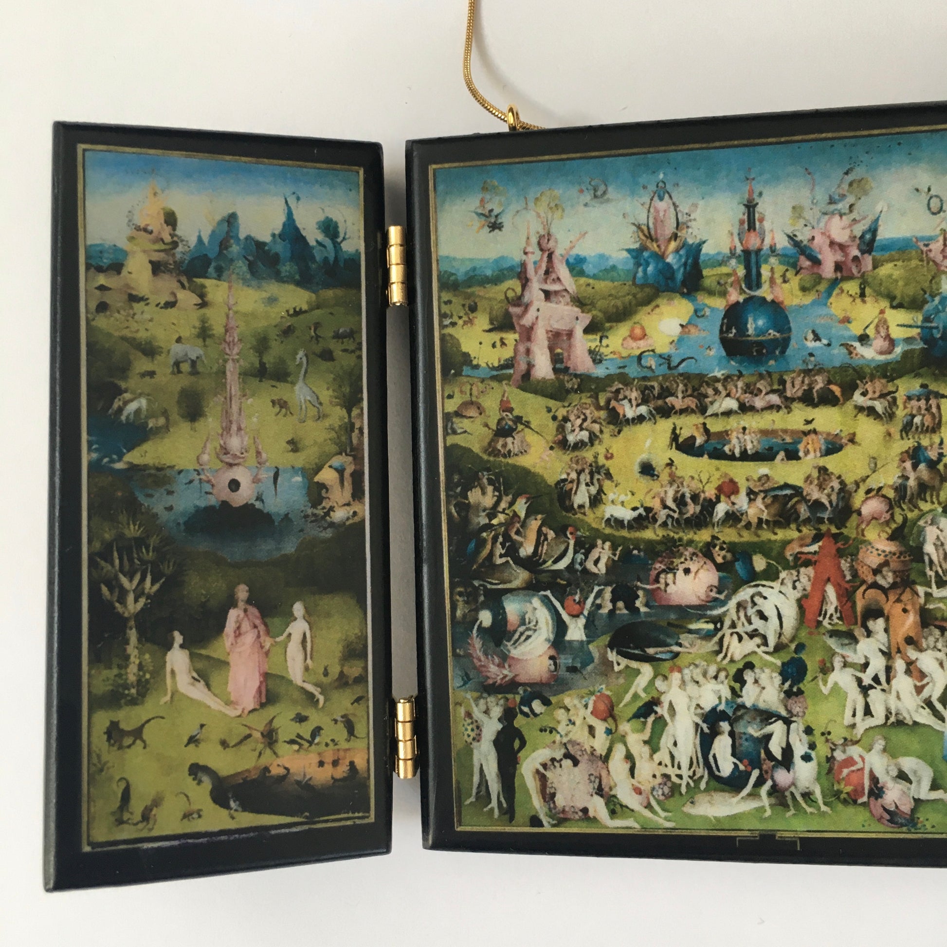 A fully functioning, reproduction in miniature of the three panelled masterpiece, Garden of Earthly Delights by Hieronymus Bosch, turned into a beguiling necklace. 