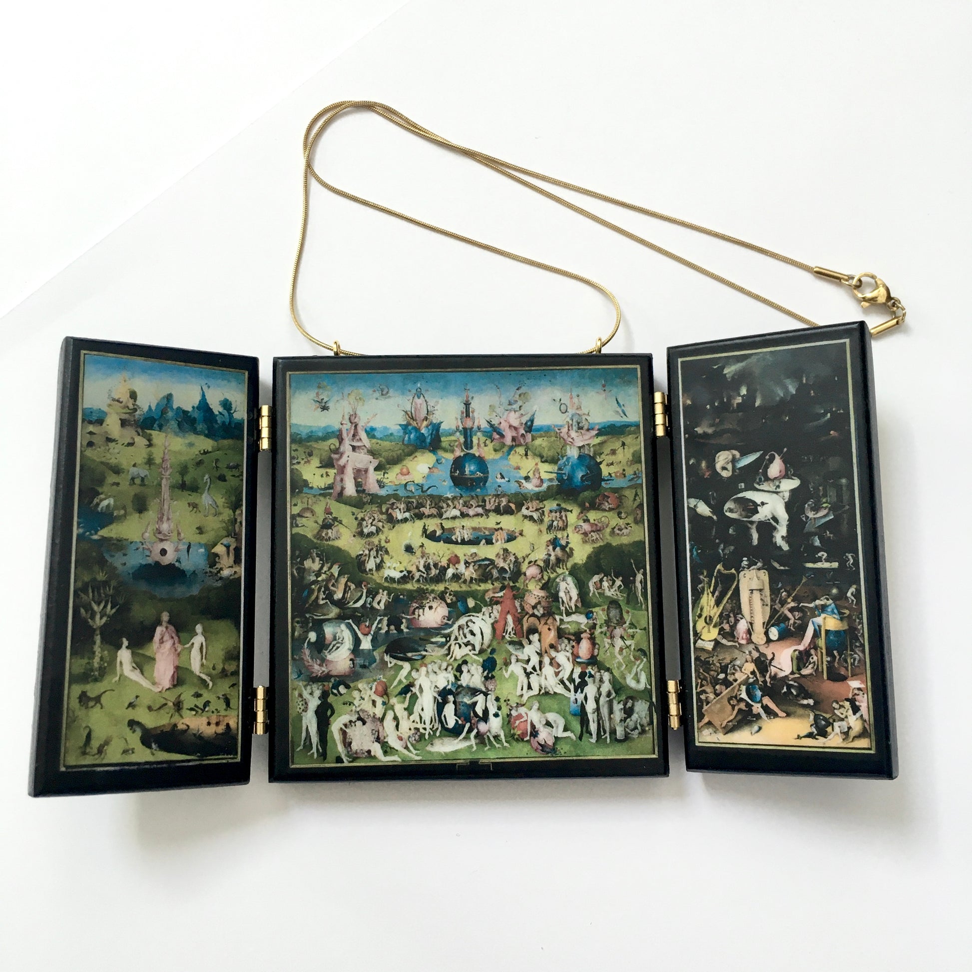 A fully functioning, reproduction in miniature of the three panelled masterpiece, Garden of Earthly Delights by Hieronymus Bosch, turned into a beguiling necklace. 