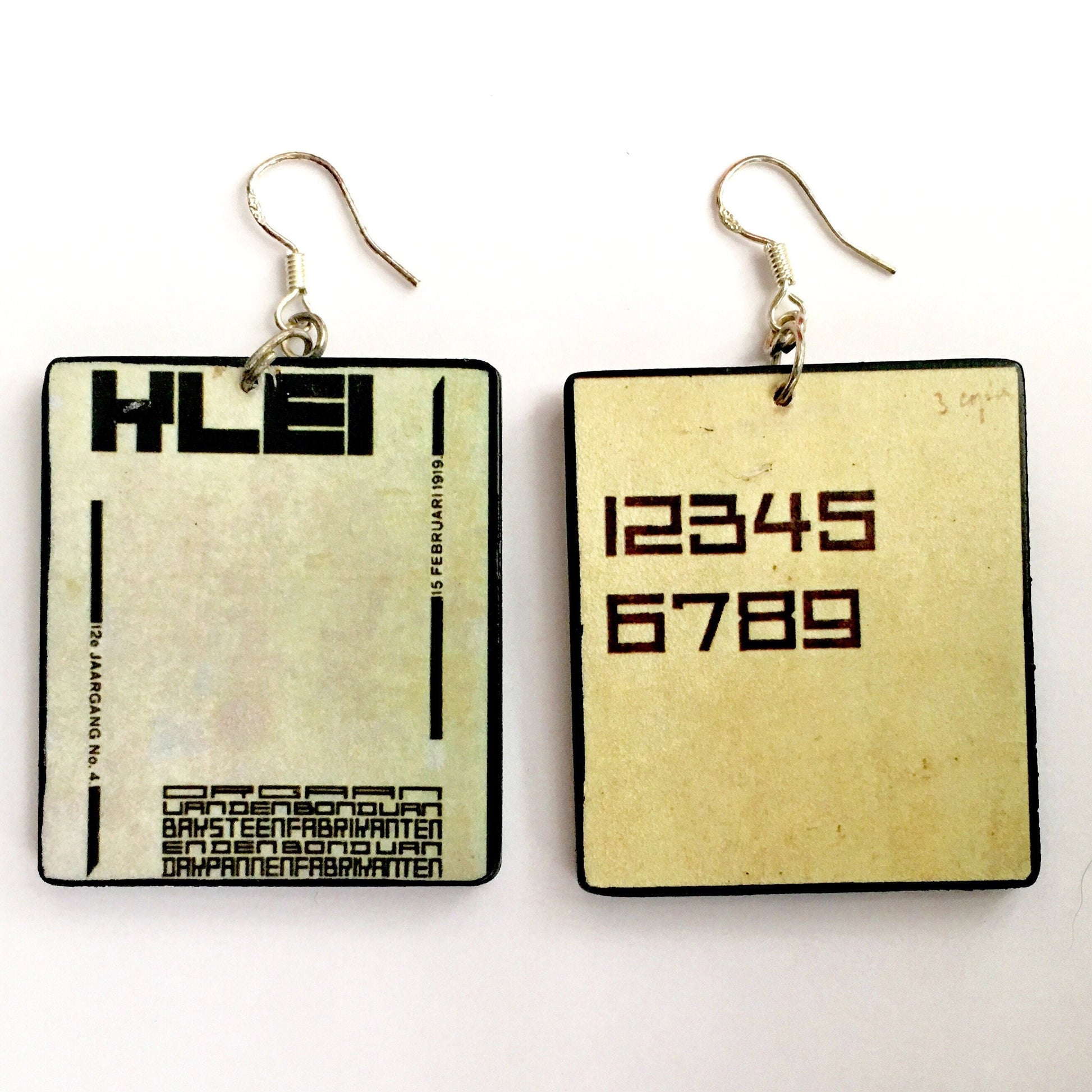 Handmade art earrings inspired by De Stijl art movement and his founded by Theo van Doesburg. Sustainable, mismatched earrings on wood with geometric, abstract art.