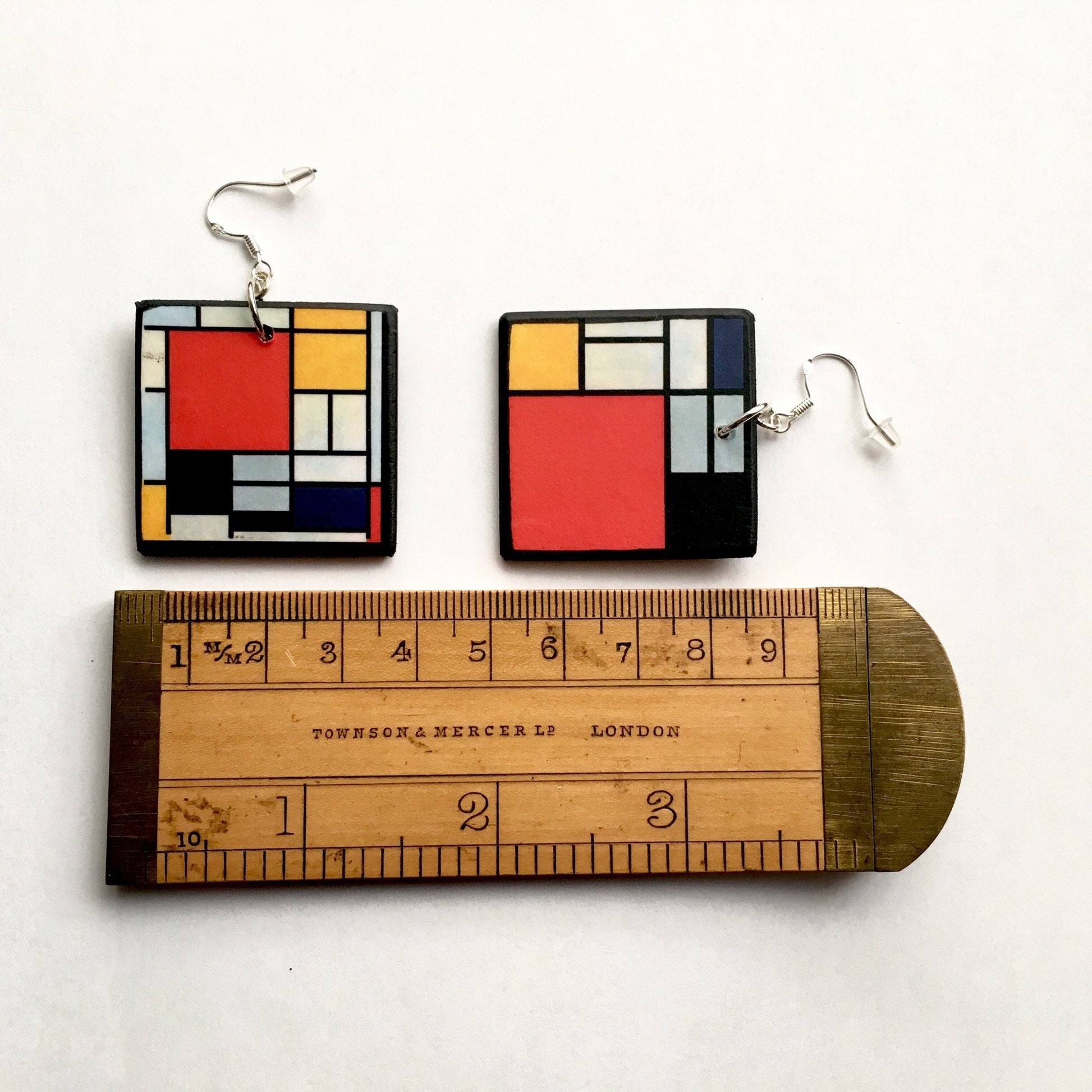 Mondrian inspired earrings are wearable art earrings handmade by Obljewellery. Primary colours, blue, yellow and red are used in abstract, geometric shapes.