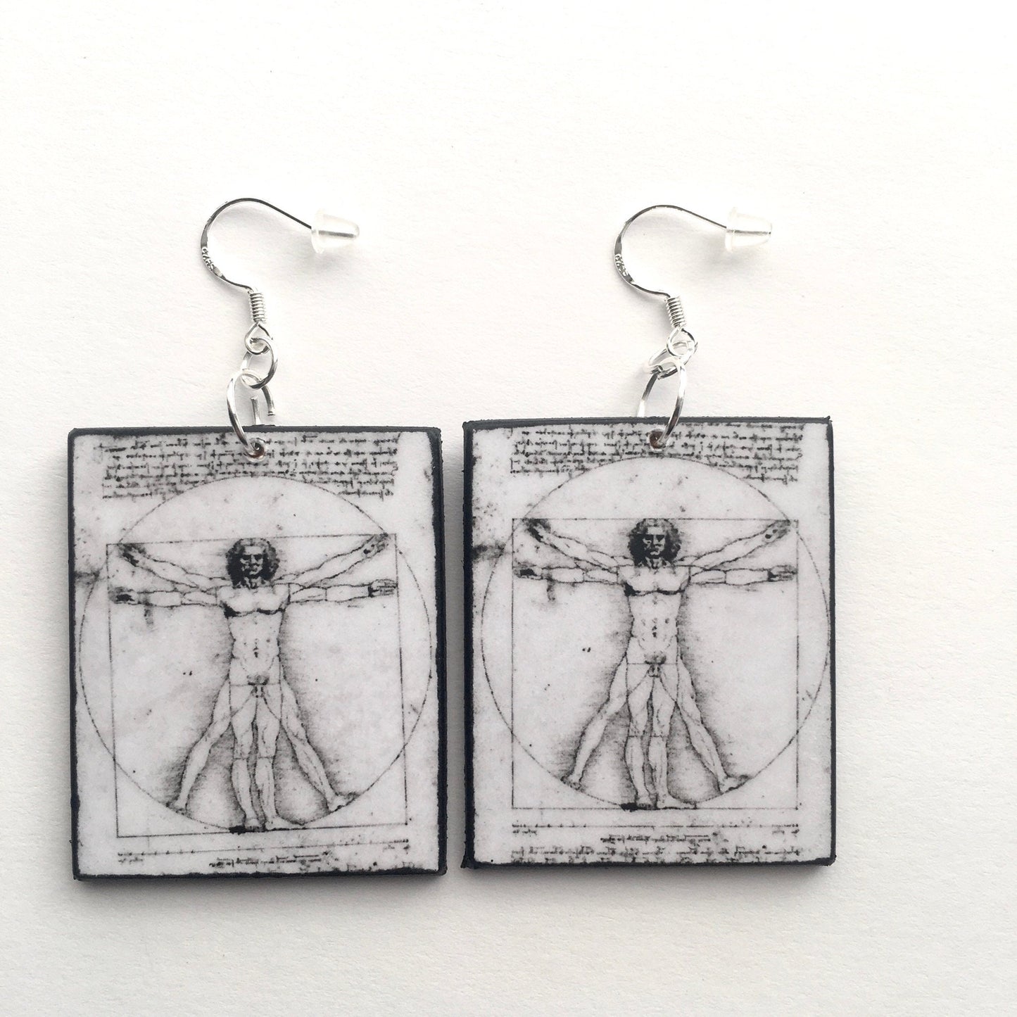 Leonardo da Vinci earrings. Black and white, sustainable art earring with "Vitruvian Men" sacret geometry art. Obljewellery Leonardo da Vinci collection.