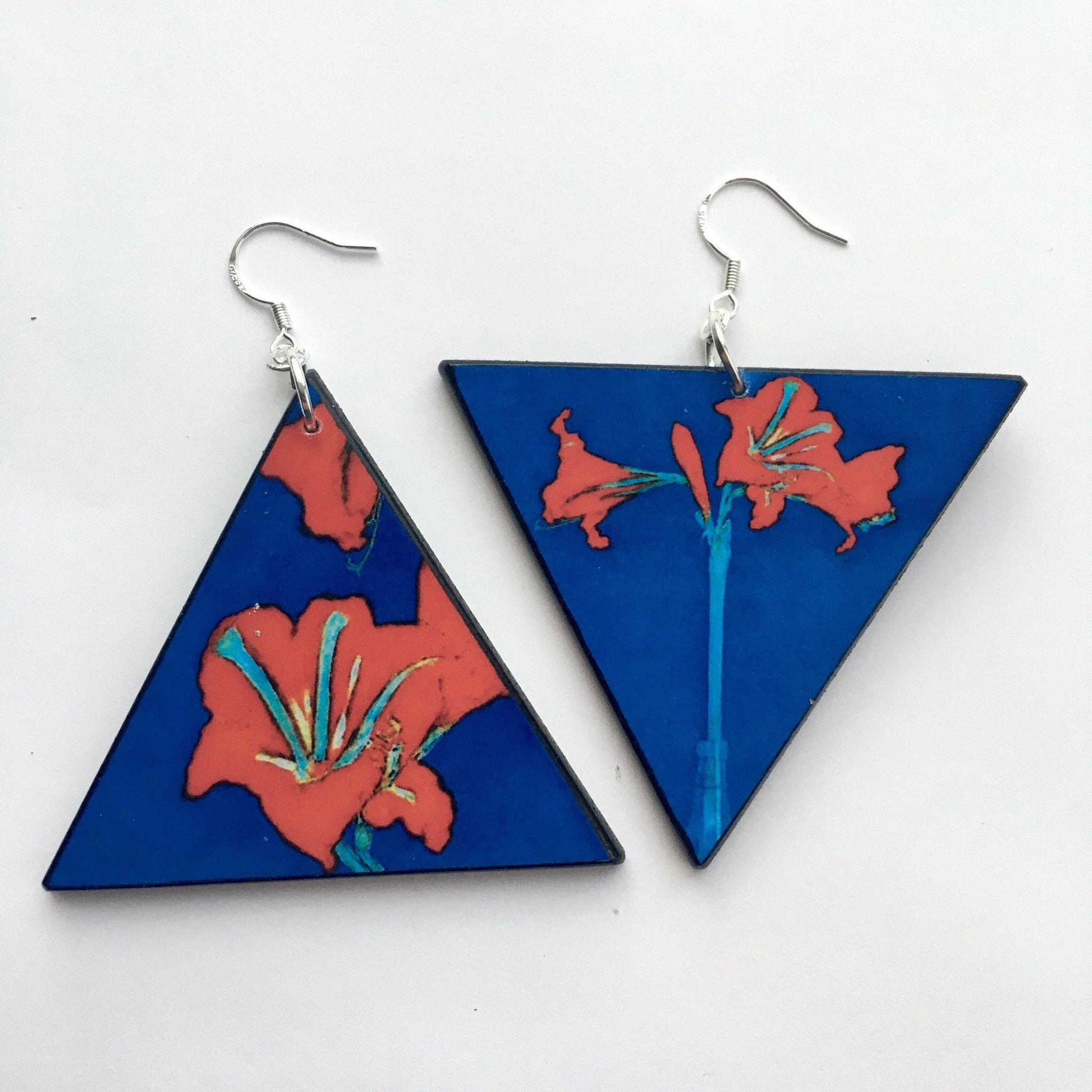 Triangle earrings with an art detail of Mondrian painting. Red flowers and blue color. Sustainable handmade earrings on wood by Obljewellery.