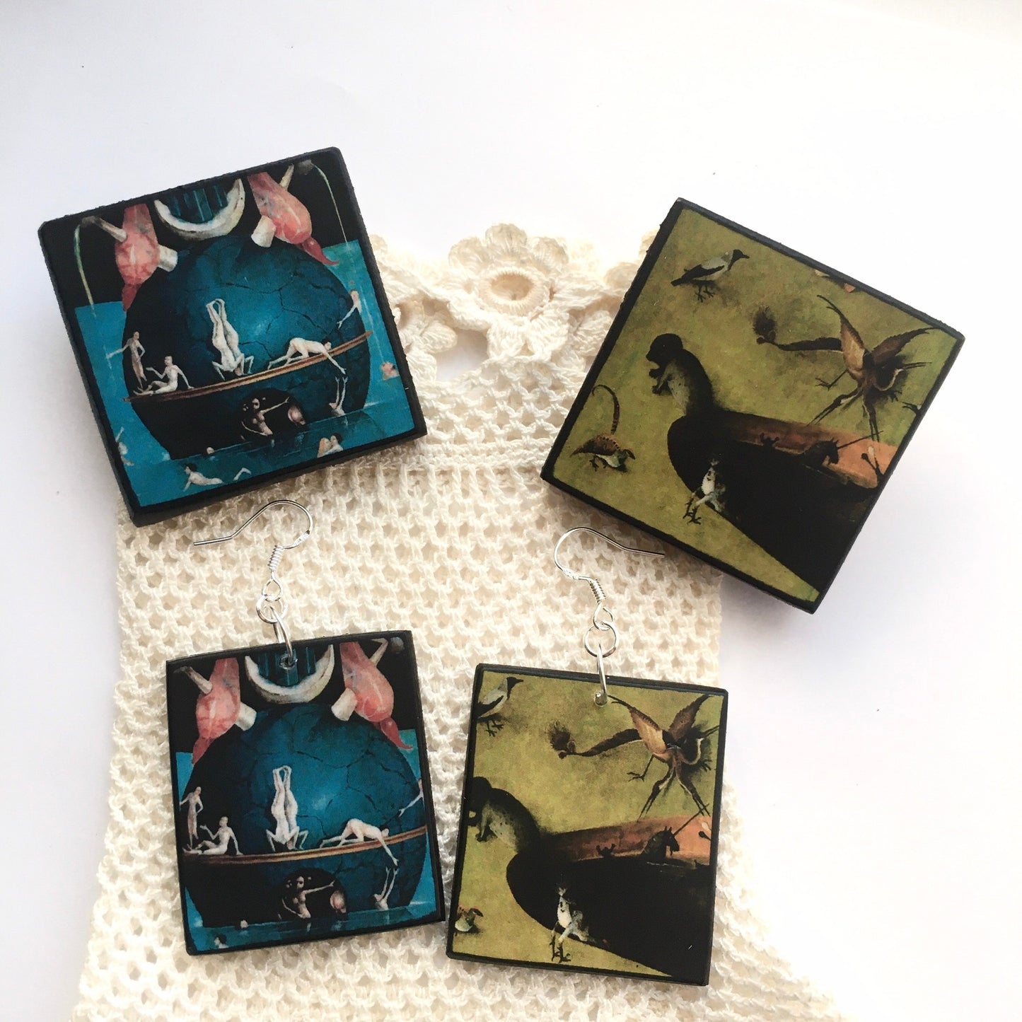 Set of mismatched earrings and one brooch based on Hieronymus Bosch art.