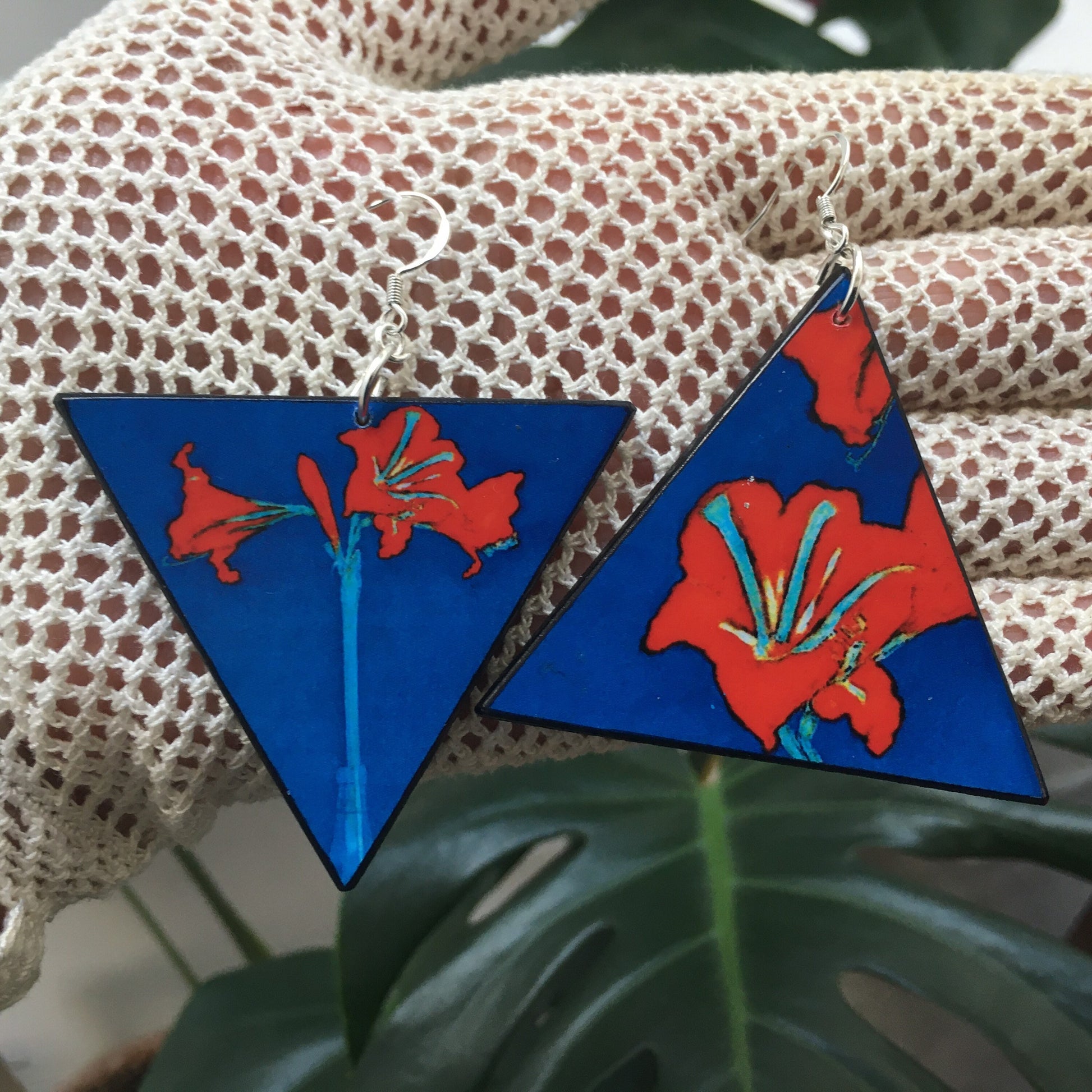 Triangle earrings with an art detail of Mondrian painting. Red flowers and blue color. Sustainable handmade earrings on wood by Obljewellery.
