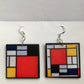 Mondrian inspired earrings are wearable art earrings handmade by Obljewellery. Primary colours, blue, yellow and red are used in abstract, geometric shapes.
