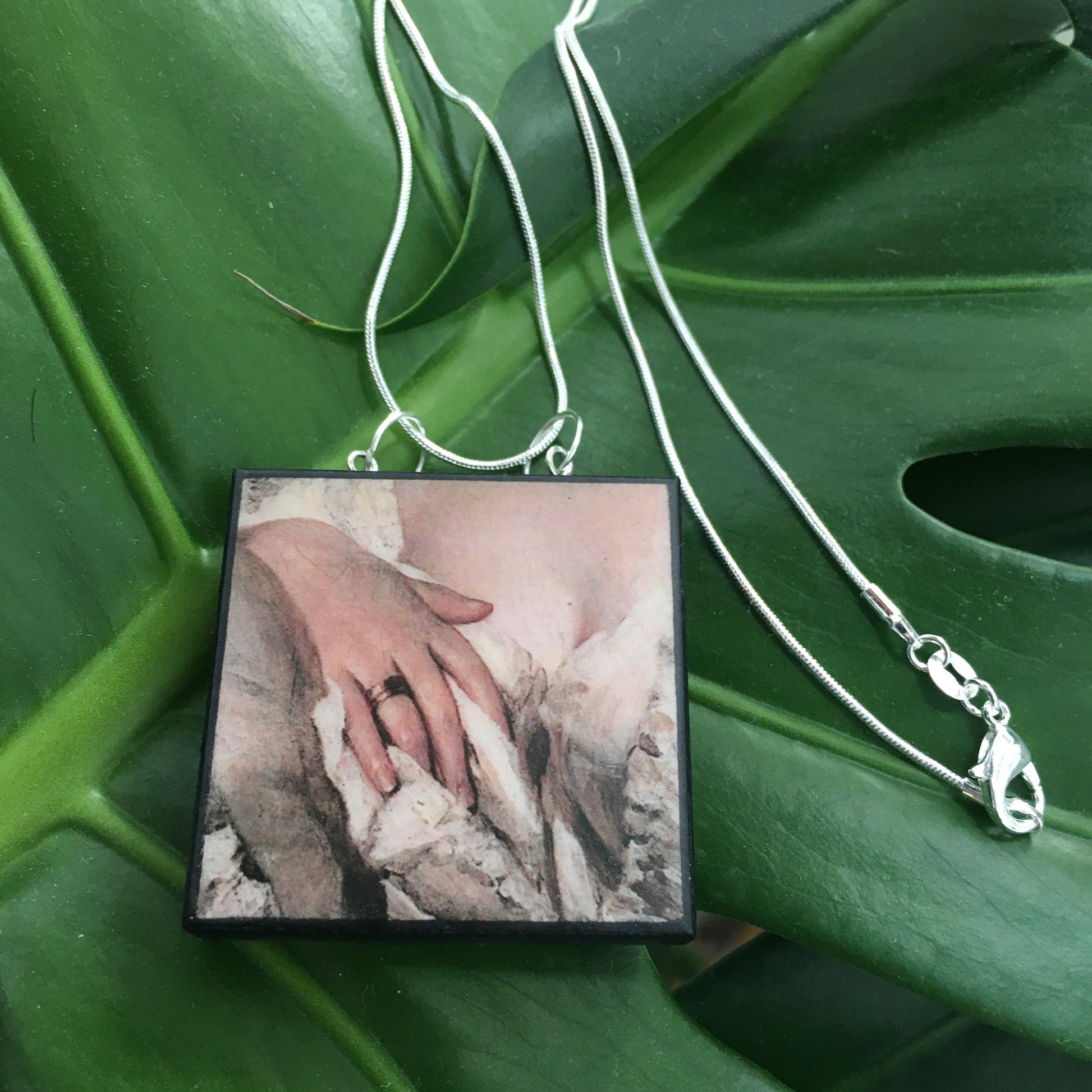 Statement necklace sterling silver chain with a wooden squared pendant inspired by a sensual art detail of a hand. quirky gift on obljewellery shop.