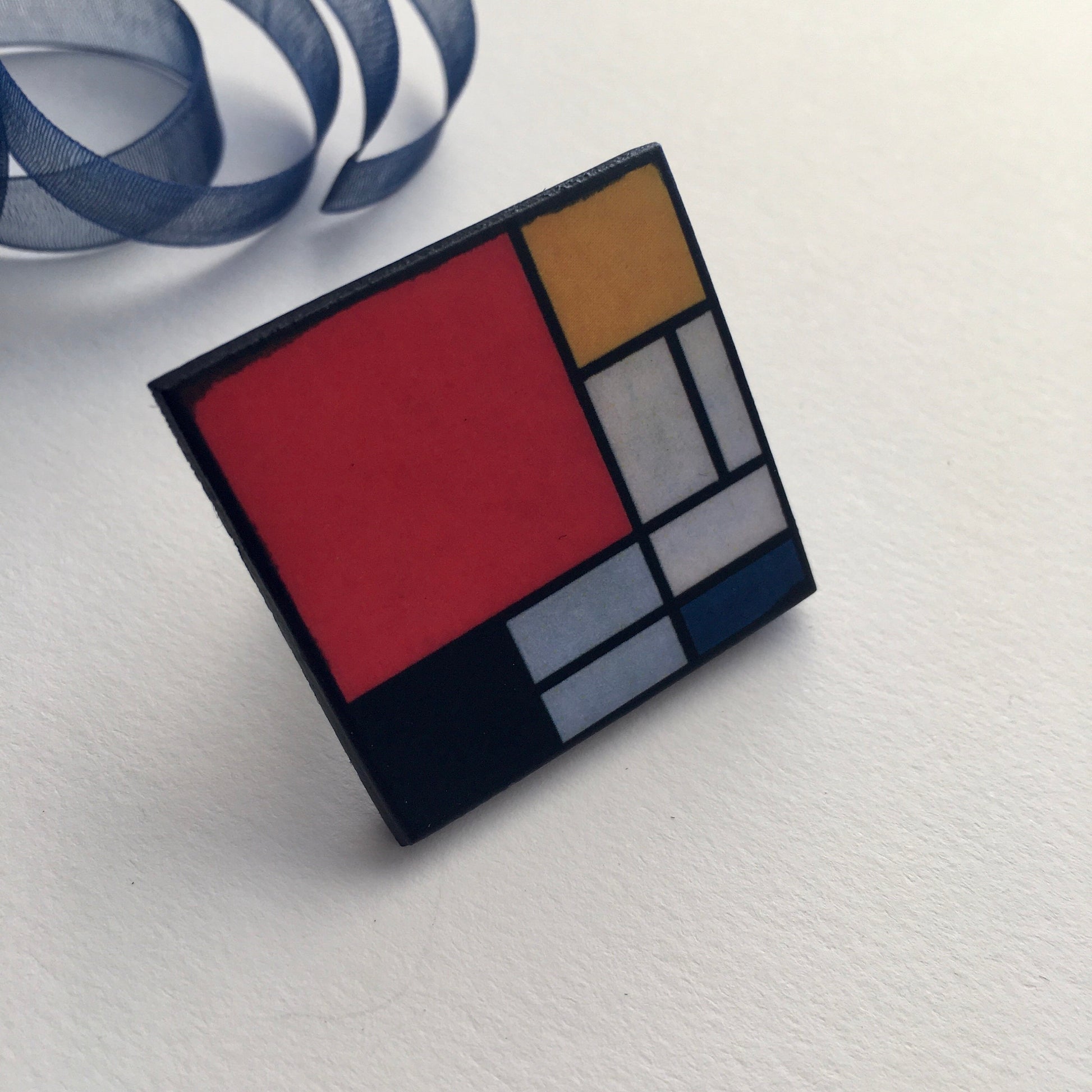 Wooden, 3.5 cm squared geometric art ring in red, blue, yellow and white colors. Obljewellery shop is inspired by Mondrian's De Stijl period works.