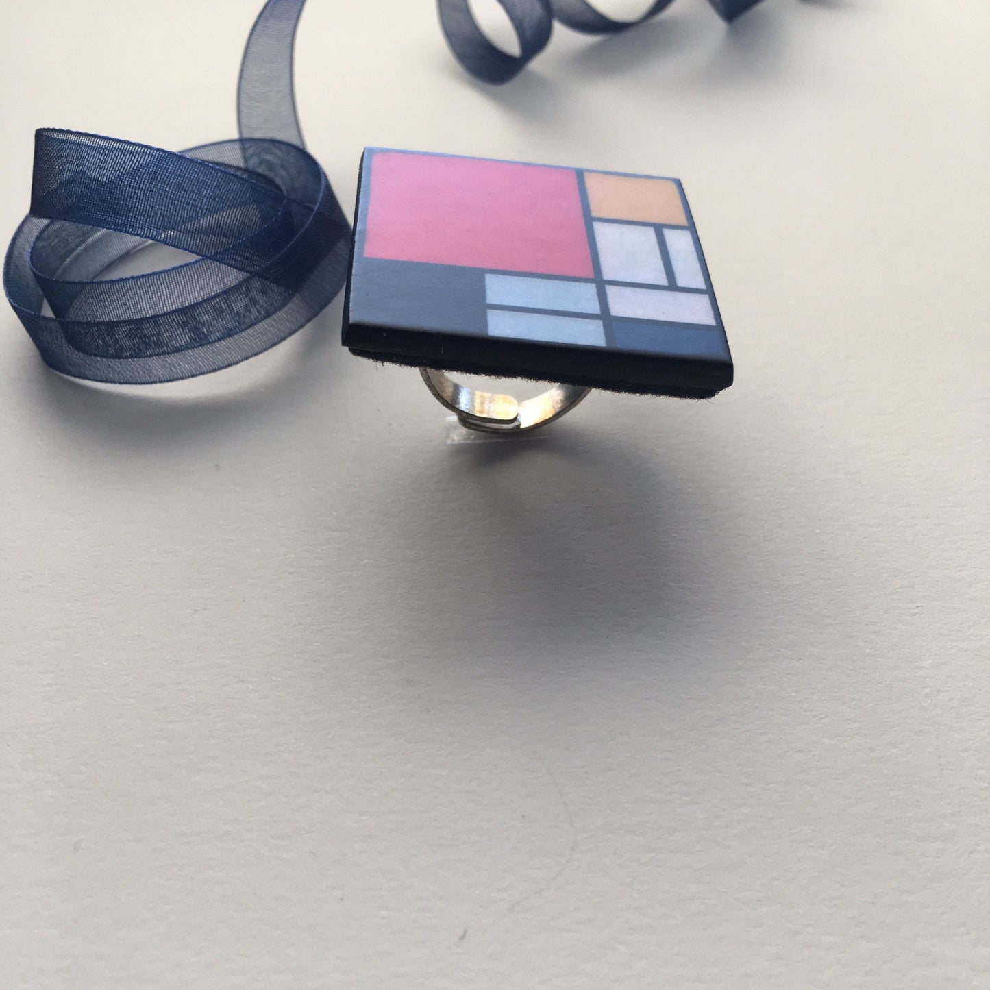 Wooden, 3.5 cm squared geometric art ring in red, blue, yellow and white colors. Obljewellery shop is inspired by Mondrian's De Stijl period works.