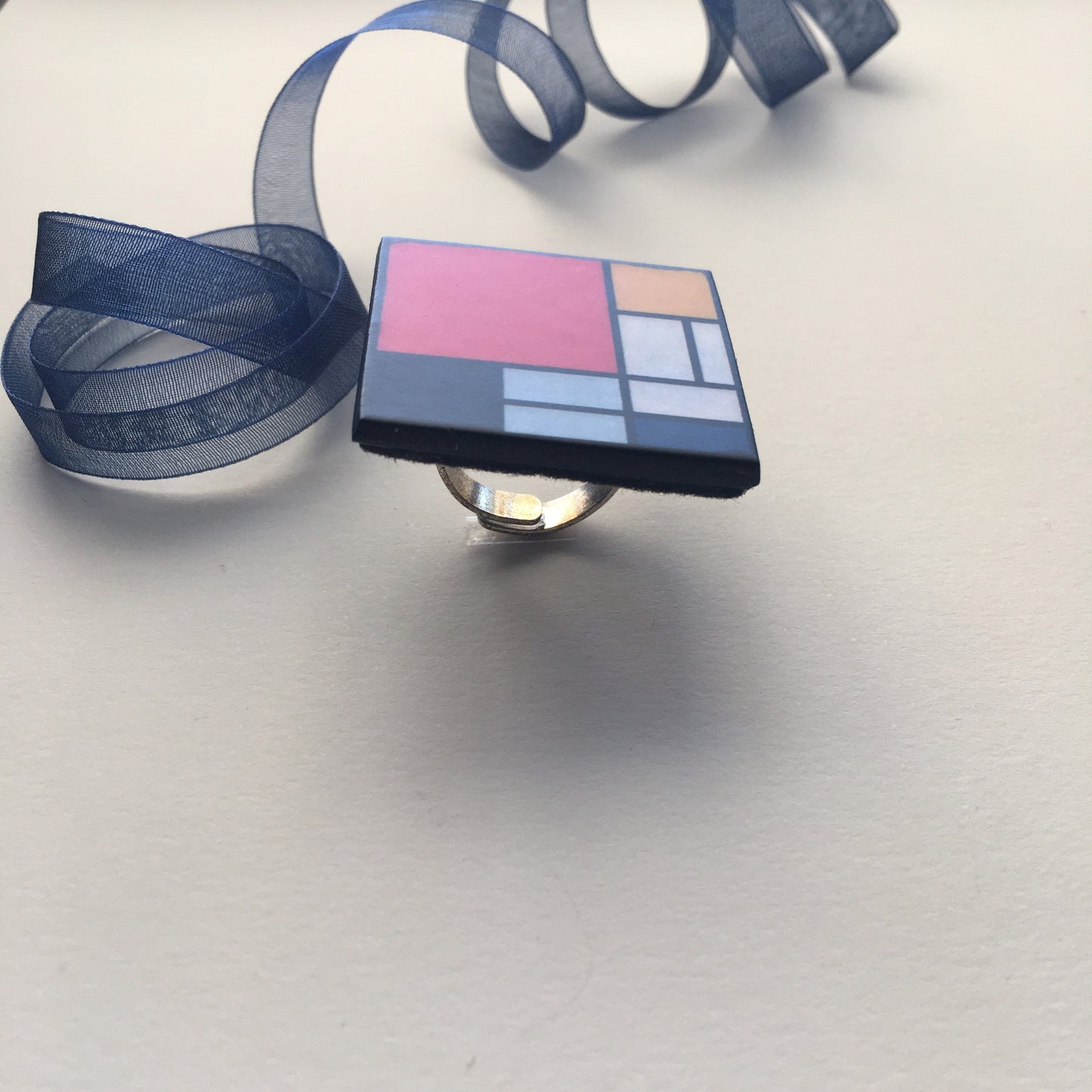 Wooden, 3.5 cm squared geometric art ring in red, blue, yellow and white colors. Obljewellery shop is inspired by Mondrian's De Stijl period works.