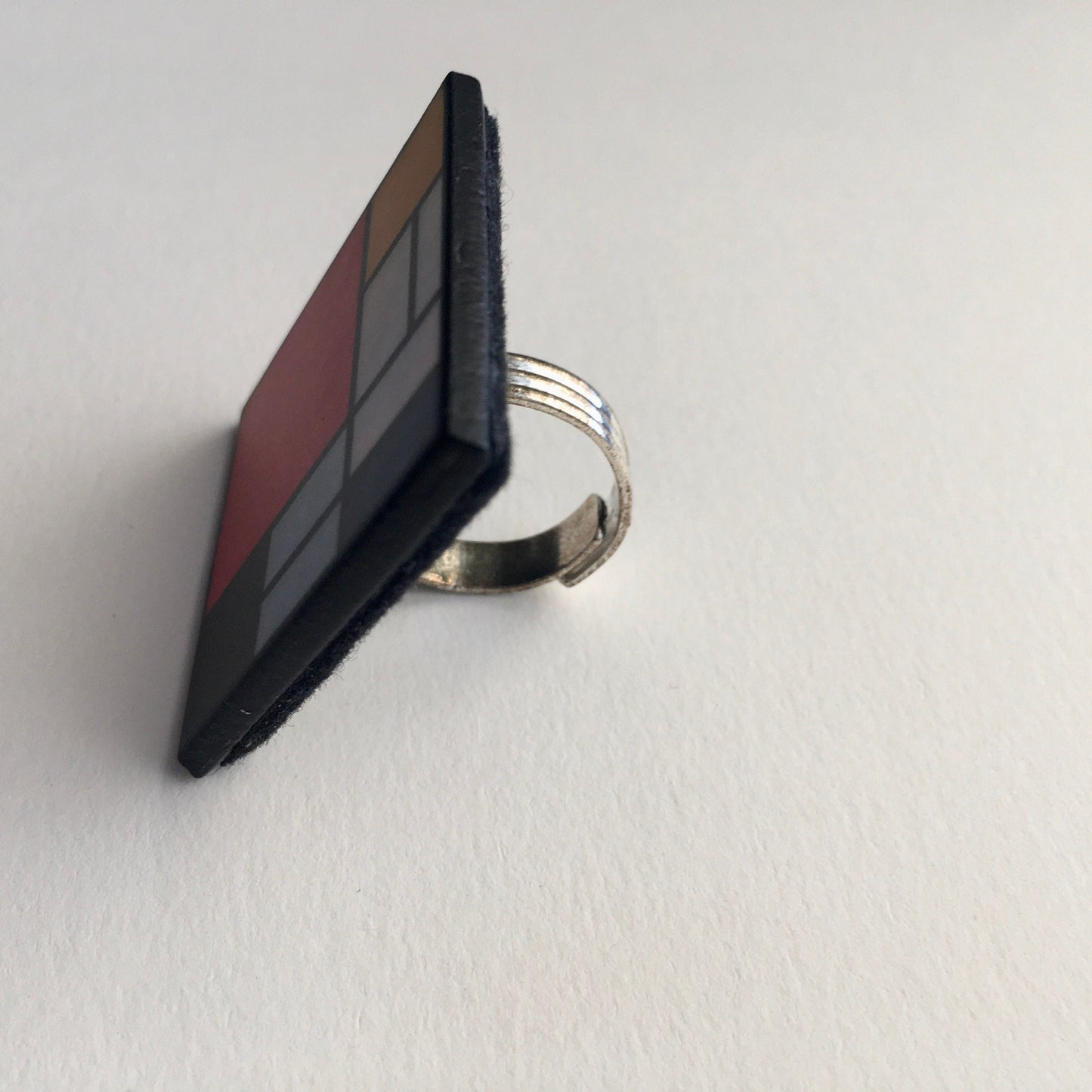 Wooden, 3.5 cm squared geometric art ring in red, blue, yellow and white colors. Obljewellery shop is inspired by Mondrian's De Stijl period works.