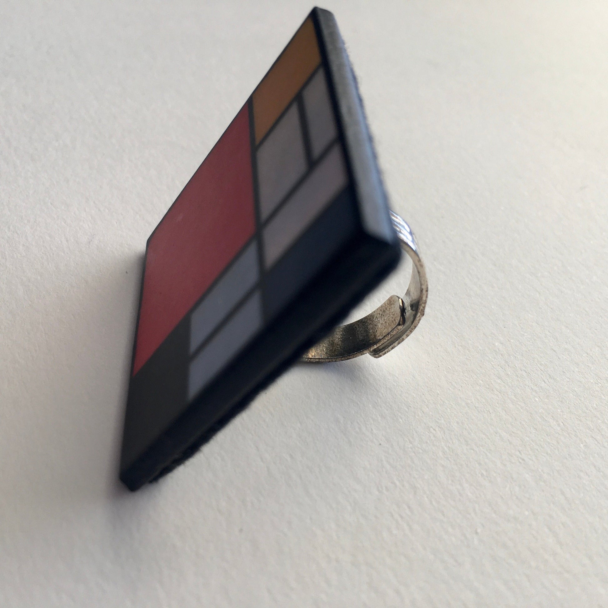 Wooden, 3.5 cm squared geometric art ring in red, blue, yellow and white colors. Obljewellery shop is inspired by Mondrian's De Stijl period works.