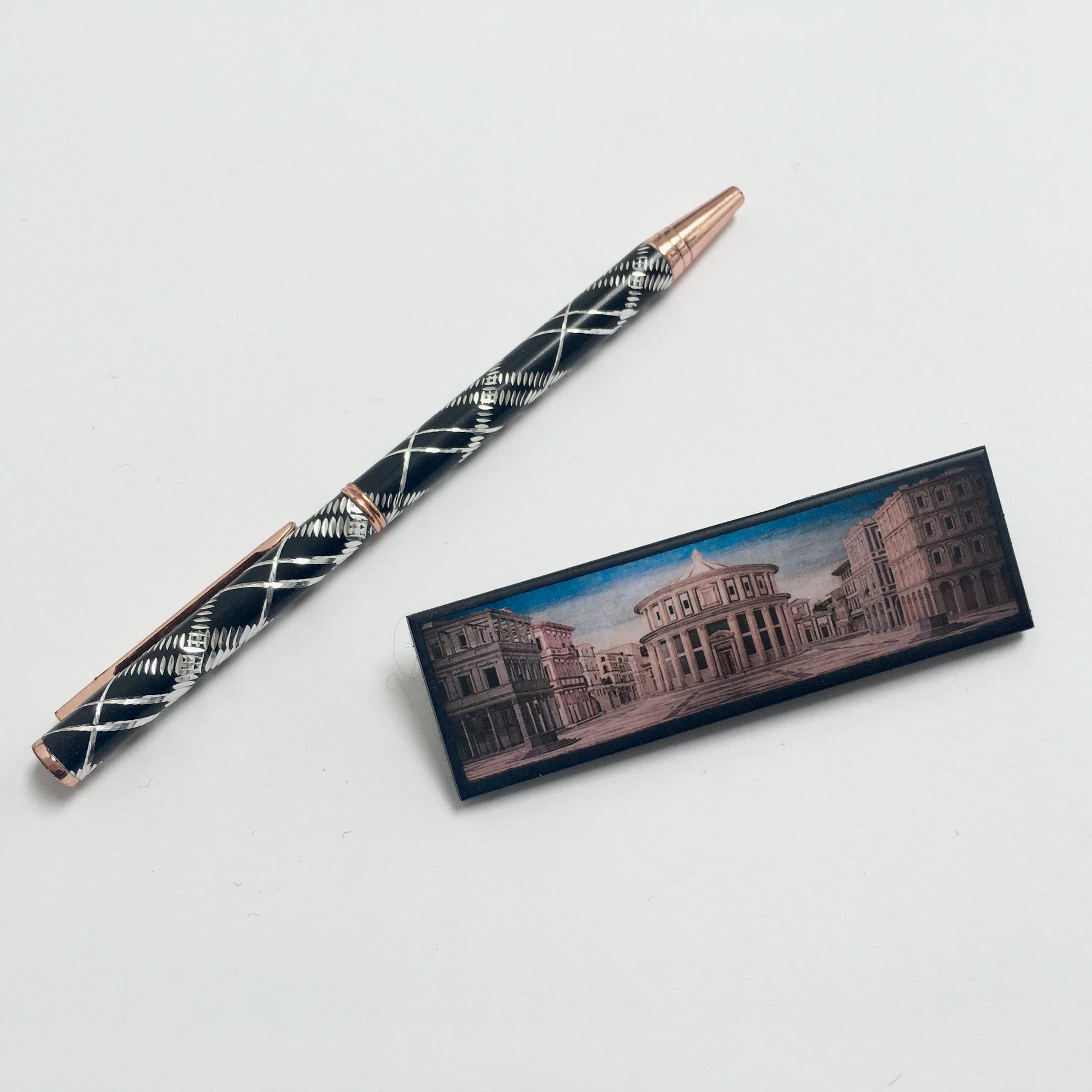 The Ideal City of Urbino art painting inspired Obljewellery to design this statement brooch handmade from sustainable wood. Aesthetic art brooch perfect artsy gift for her and him. The brooch is near a pen to see the propotions.
