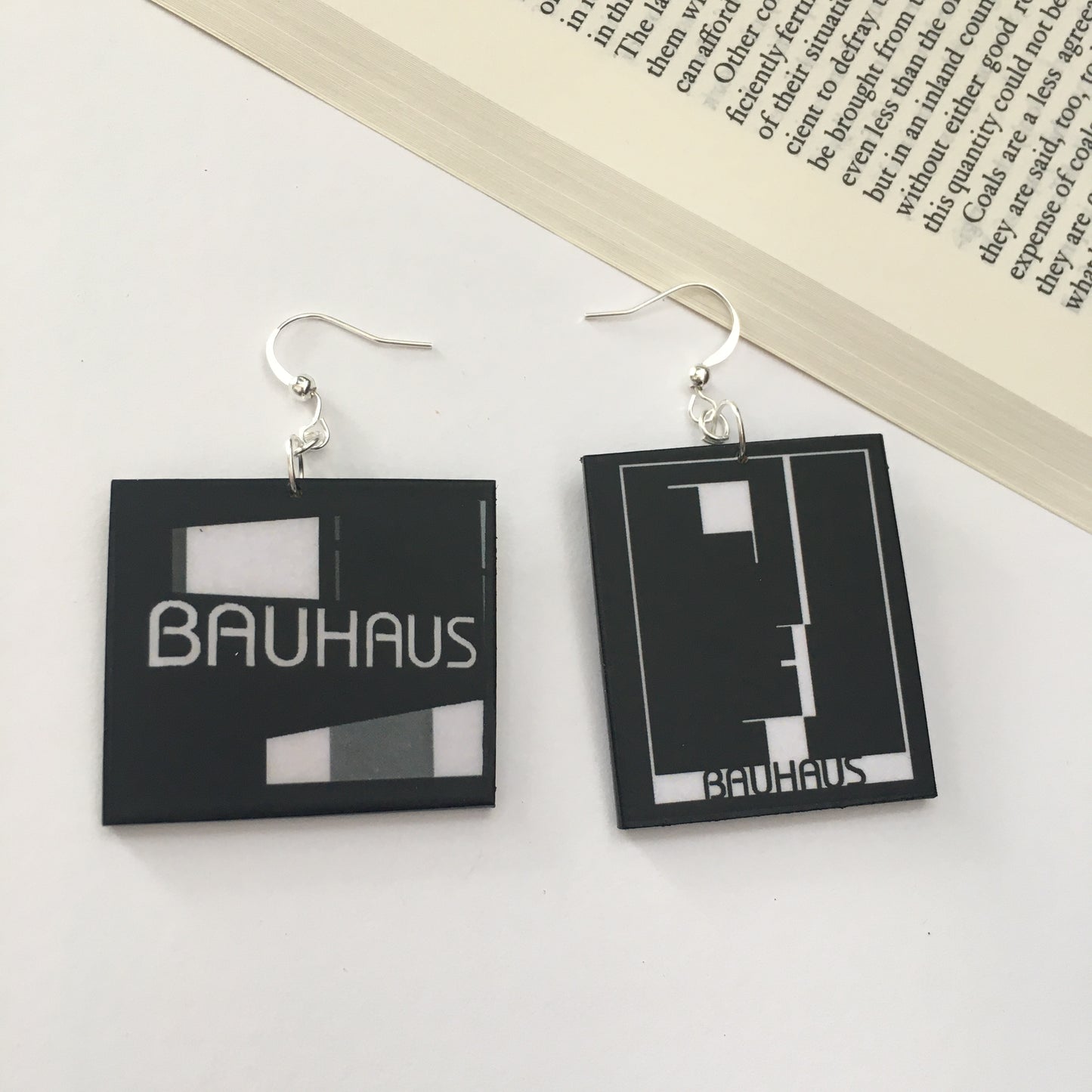 Sustainable, asymmetrical art earrings inspired by the Bauhaus emblem, designed by Oskar Schlemmer.