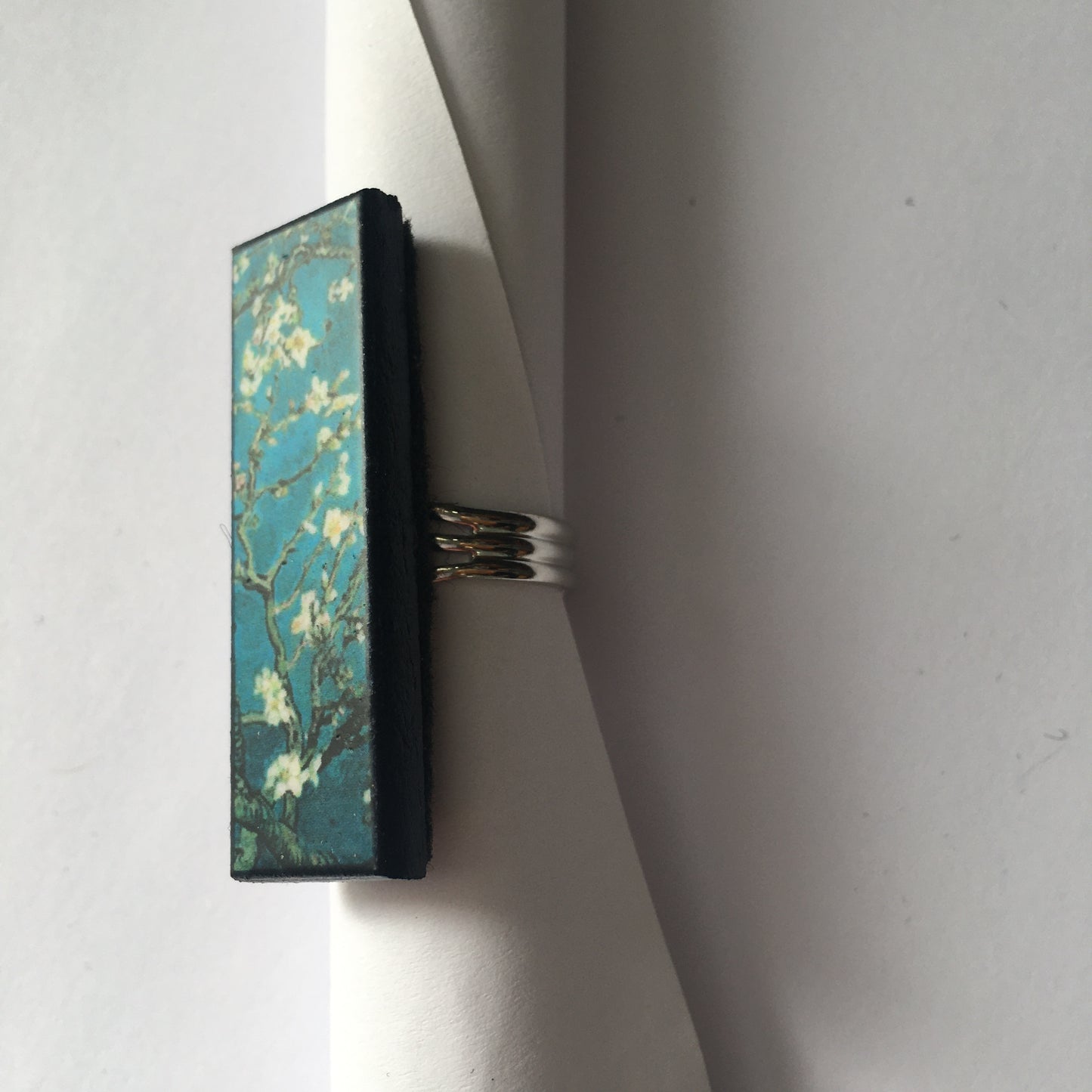 Inspired by the Van Gogh painting Almond Blossom, Obljewellery handmade from sustainable wood this rectangular ring with adjustable silver colour band ring. White flowers against turquoise sky.  
