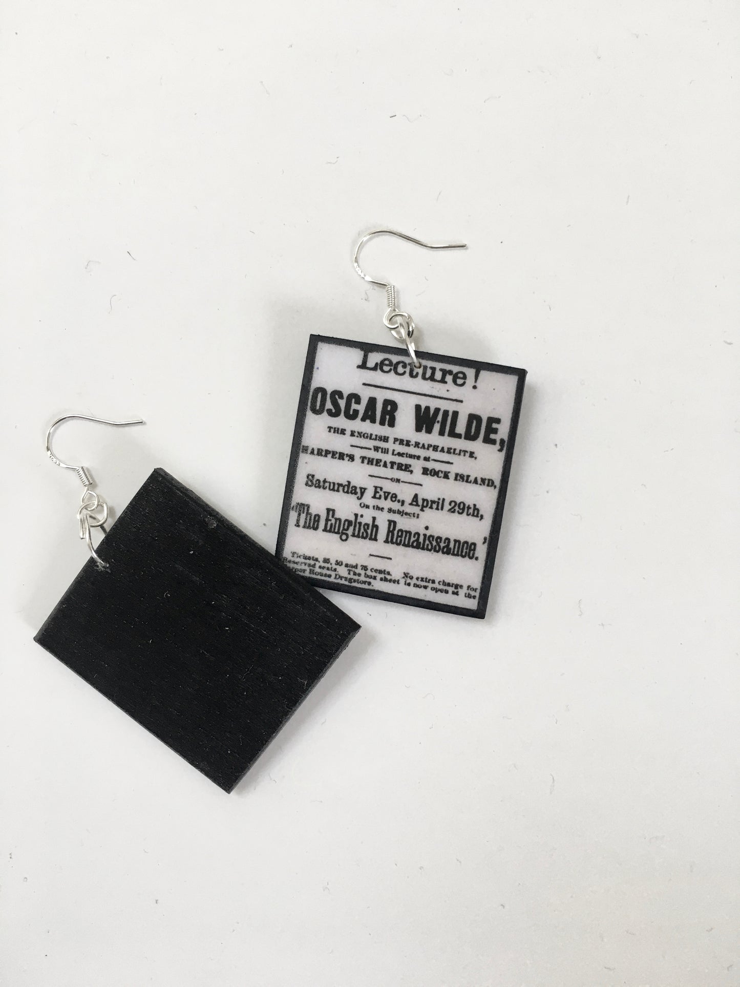 handmade art earrings with the page of newspaper with Lectures, Oscar Wilde at Harper's Theatre 29 April. sustainable artsy earrings by Obljewellery.
