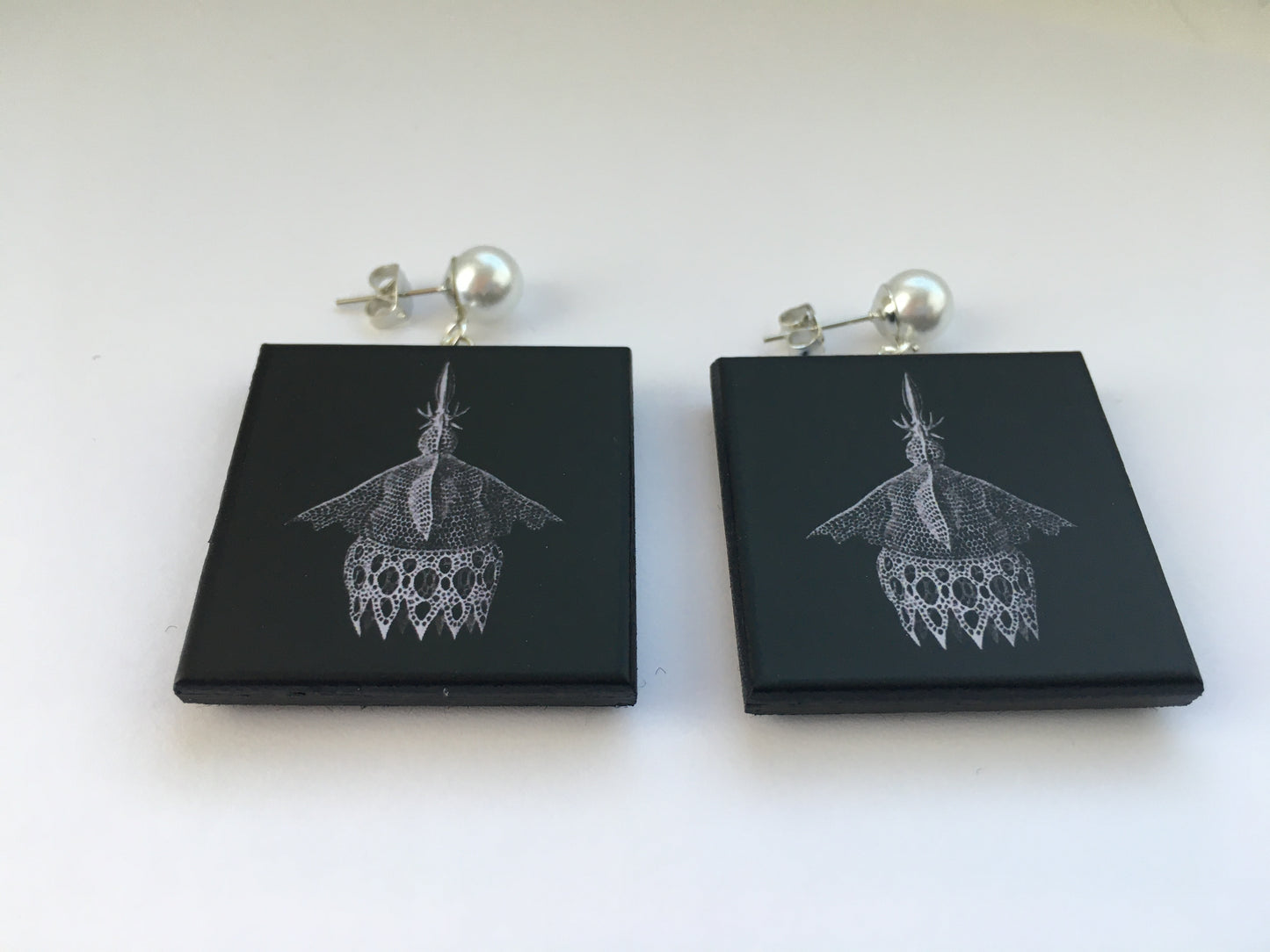 Sustainable wood earrings with stud pearls inspired by Ernst Haeckel marine shells, radiolaria black and white illustration. These earrings are completely handmade by Obljewellery