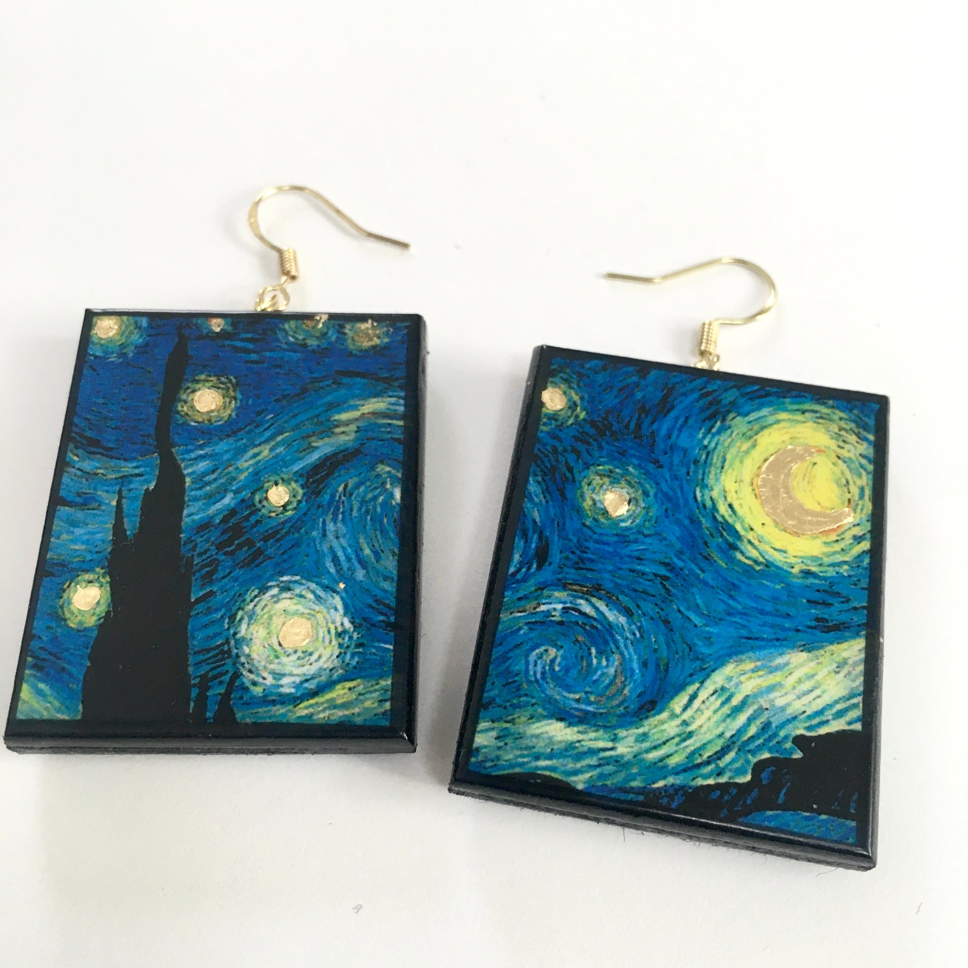 Earrings shaped rectangular with some art details in gold leaf inspired by Vincent Van Gogh's "Starry Night" painting. Blue sky and gold little stars dangle earrings in sustainable wood. Handmade by Obljewellery