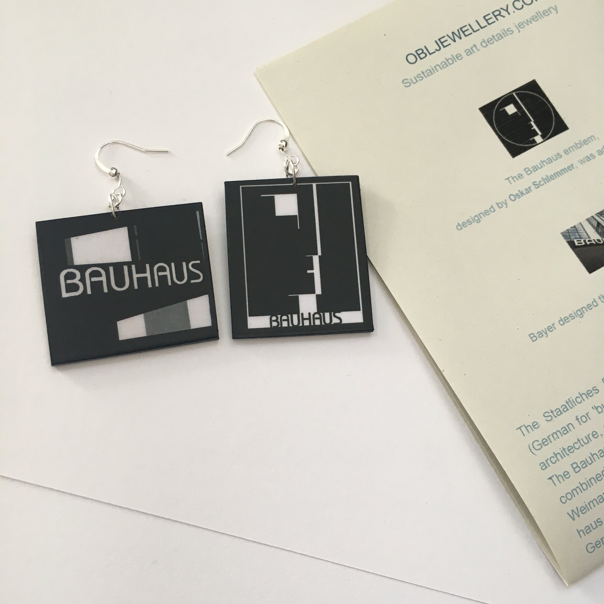 Sustainable, asymmetrical art earrings inspired by the Bauhaus emblem, designed by Oskar Schlemmer.